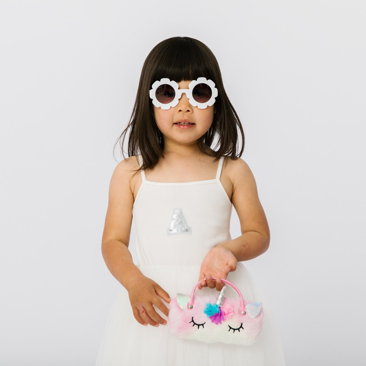 Add our fashion flower sunglasses and plush unicorn handbag